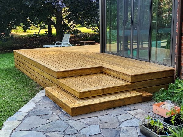 Beautiful Cedar deck with flagstone patio by Creative Decks Niagara